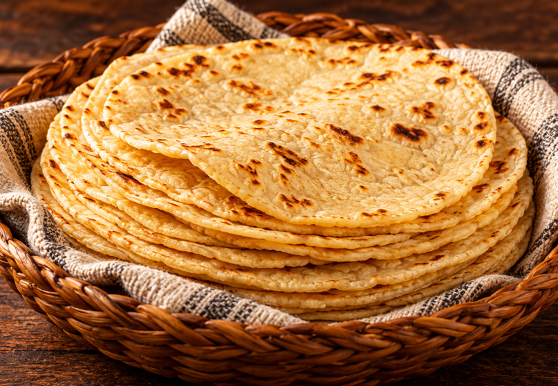Stack of soft homemade corn tortillas